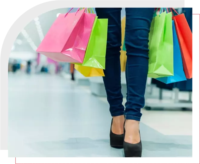 A woman is holding shopping bags in her hand.