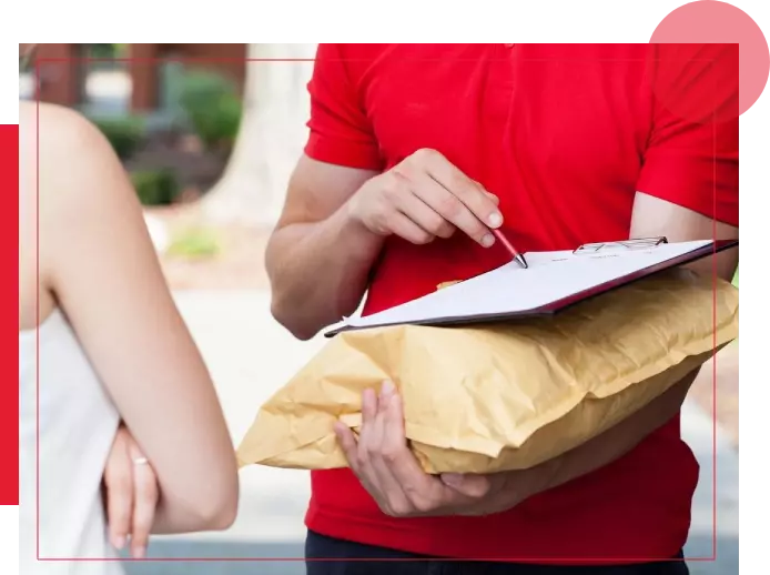 A woman holding a bag and writing on paper.